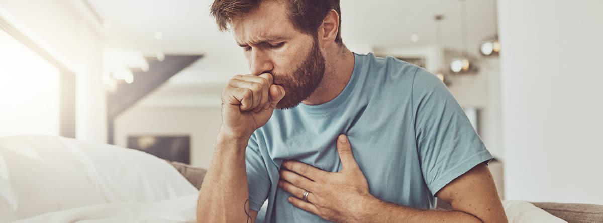 Hombre tosiendo, como si tuviera problemas respiratorios